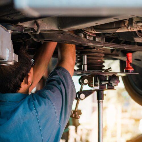 photo of mechanic repairing a car