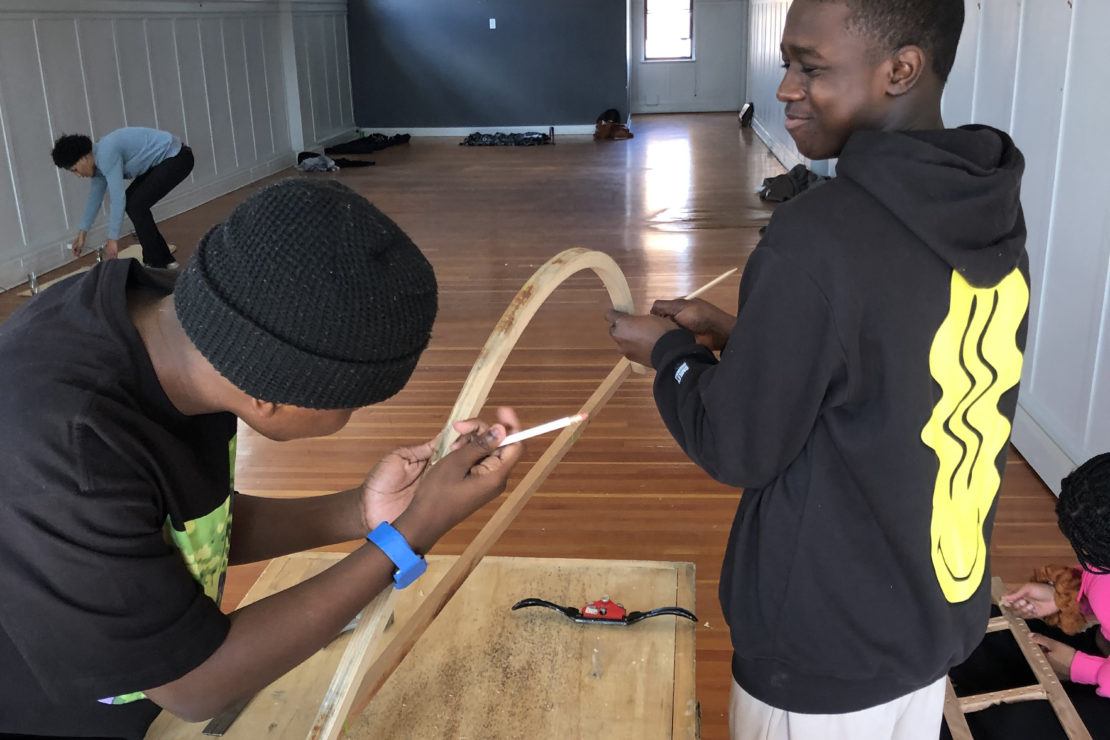 photo of two young men working together in a wood shop