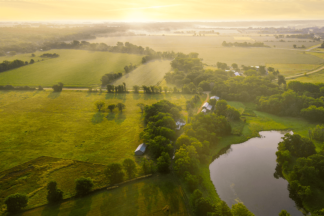 Aerial landscape of farmland at sunrise.