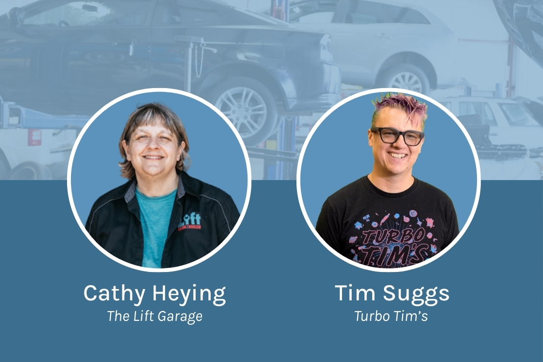 Side-by-side portraits of two individuals against a blue automotive-themed background. On the left is Cathy Heying from The Lift Garage, wearing a black jacket with the garage’s logo and smiling. On the right is Tim Suggs from Turbo Tim’s, wearing a black T-shirt with colorful lettering and pink-purple dyed hair, also smiling. Behind them is a faded image of cars being serviced in a garage.